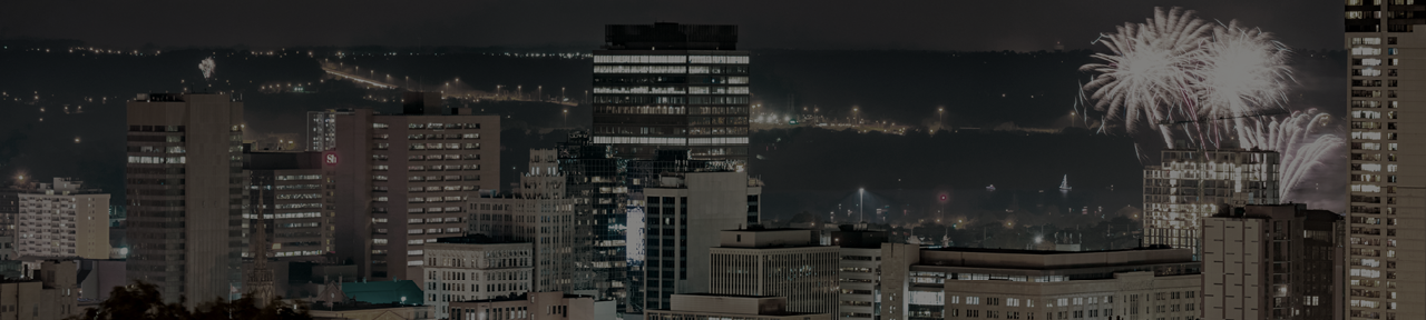 City Skyline at Night with Fireworks on Horizon