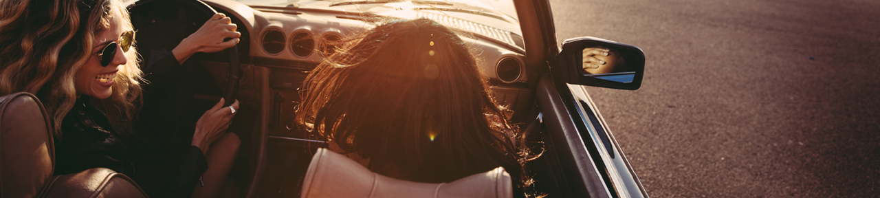 Two Woman Driving on Sunny Day in Convertible