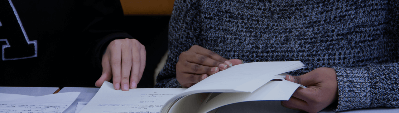 Two People Reading a Book Together