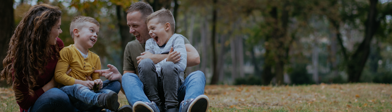 Family of Four Laughing in the Woods