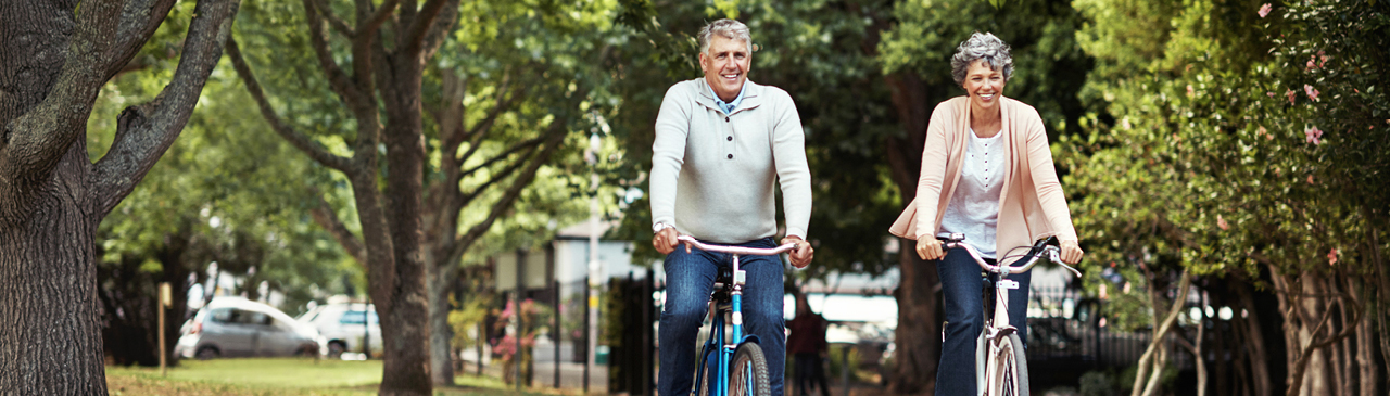 Couple Riding Bikes Through the Park