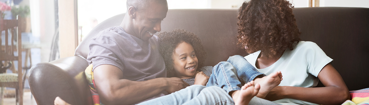 Family Smiling Together on the Couch