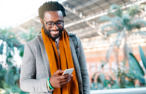 Man Smiling While Using Mobile Banking