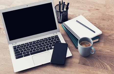 Desk with Laptop, Phone, Coffee and Stationary
