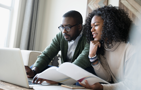 Couple Planning Their Finances on Laptop