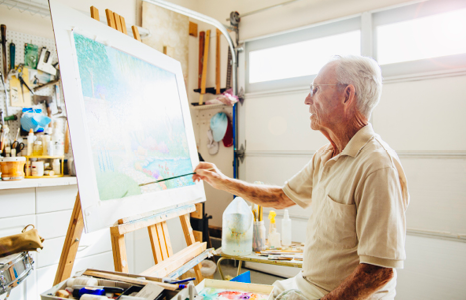 Retired Man Painting on Canvas in Garage