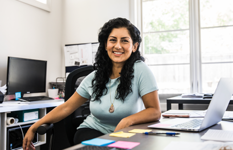 Financial Advisor Smiling While Sitting at Desk