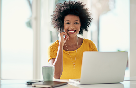 Woman Smiling While Using Online Banking On Laptop