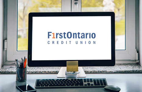 Computer with FirstOntario Credit Union Logo on Screen in Front of Window