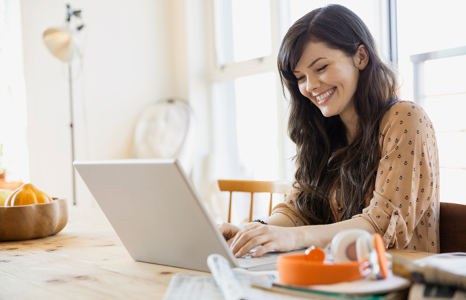 Woman Smiling While Using Online Banking in Office Studio