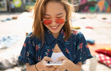 Woman using Interac e-Transfer on FirstOntario Mobile App at Beach