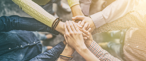 Group of People Putting Hands Together in Middle