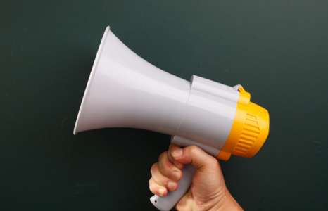 Hand holding a megaphone