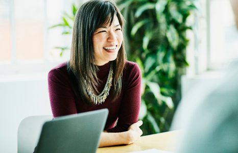 Helpful woman smiling with a laptop