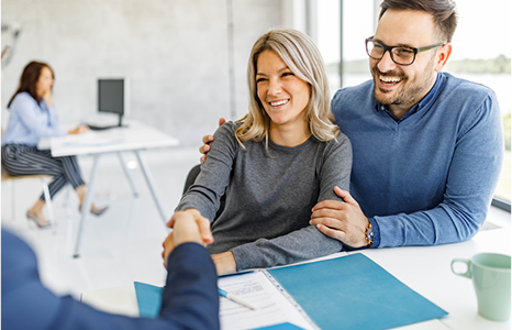 Partners Shaking Hands with Business Advisor in Office