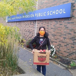 Volunteer standing in front of school