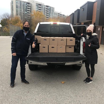 Volunteers standing with donations