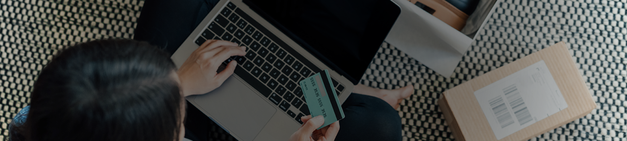 Woman Entering Debit Card to Log in to Online Banking