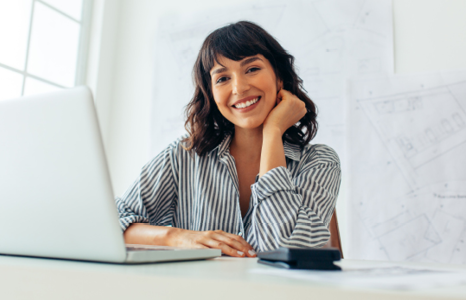 Woman in Striped Shirt Smiling and Resting Head on Hand