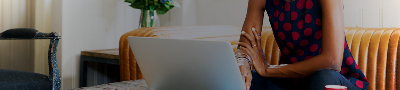 Woman sitting on the couch and using her laptop