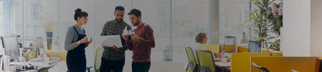 Coworkers Standing and Talking Together in Office 