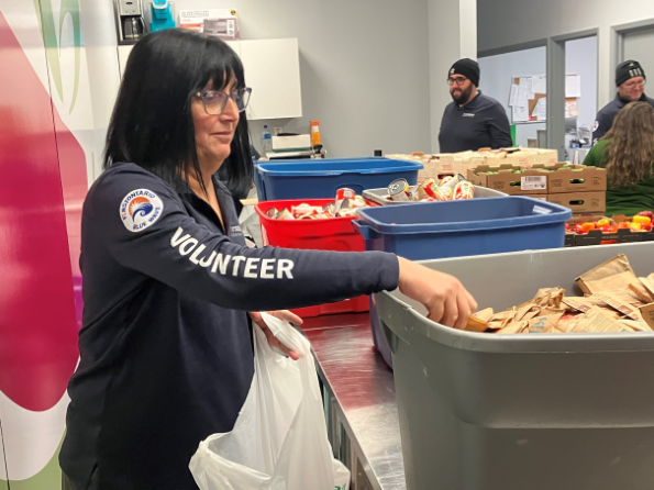 Blue Wave employee volunteer helping out at a food bank