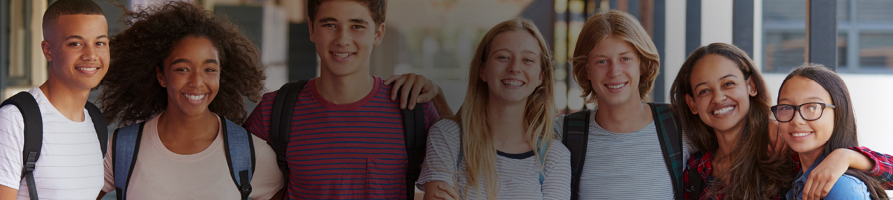 Group of young people smiling with arms around each other 