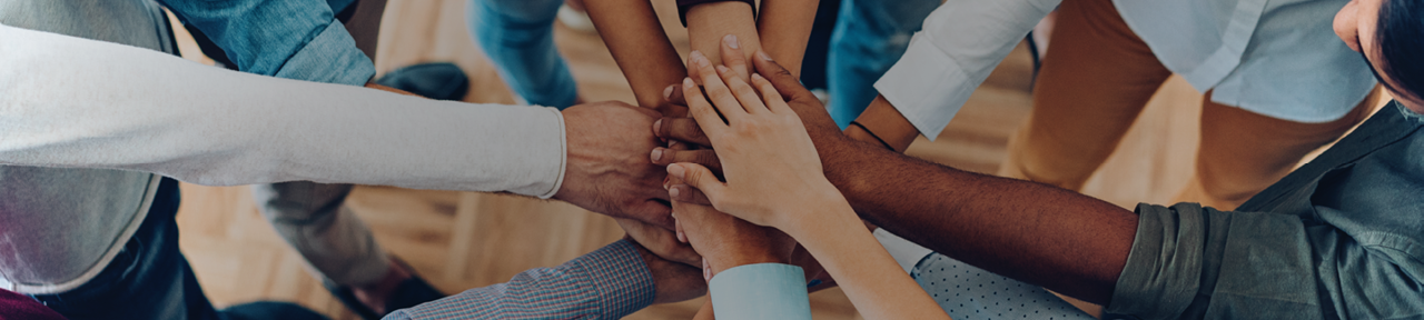 Several People Putting Hands in Circle