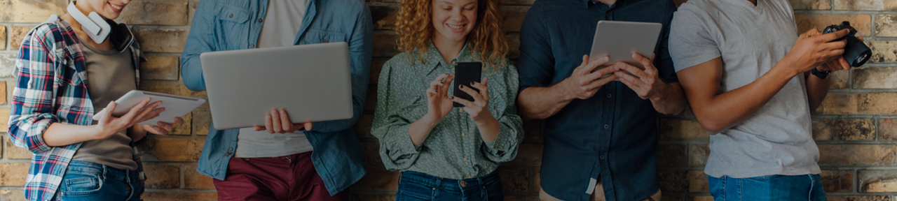 People Leaning Against Wall with Various Forms of Technology