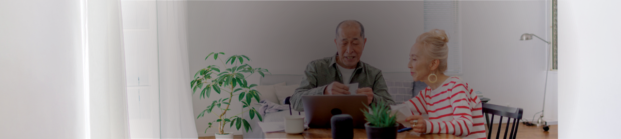 Couple Sitting at Kitchen Table Reviewing Finances