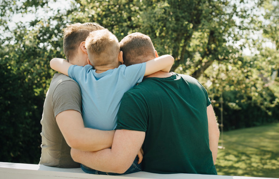 Family Embracing on a Picnic Bench Outdoors