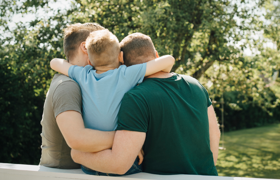 Family Sitting Together in Backyard