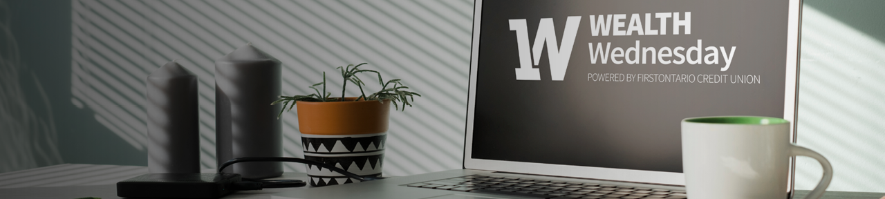 Laptop with Wealth Wednesday Logo on Screen Beside Coffee Mug