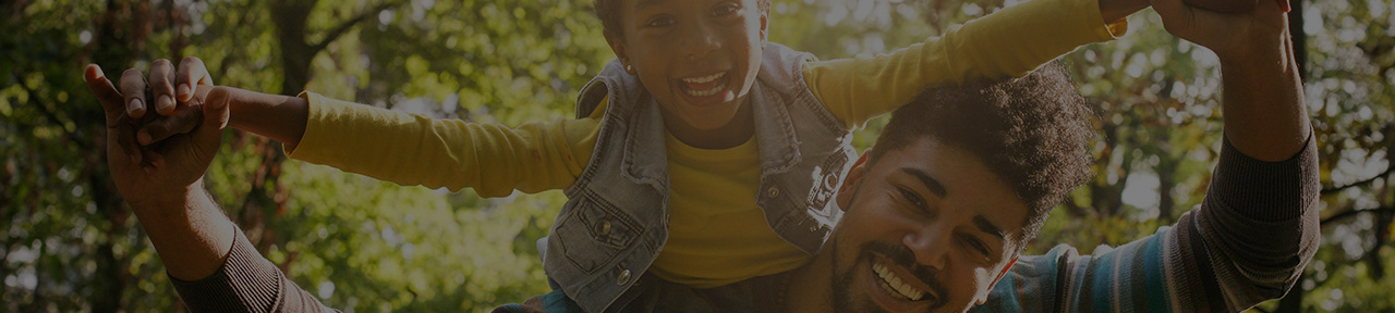 Father and son playing outside on sunny day