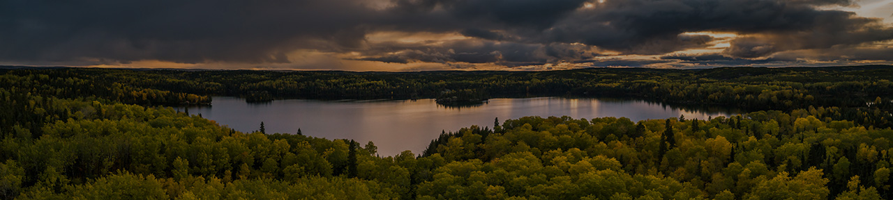 Landscape with lake and forest during sunset
