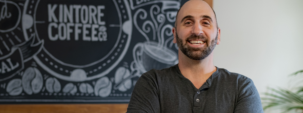 Owner of Kintore Coffee Smiling in Coffee Shop