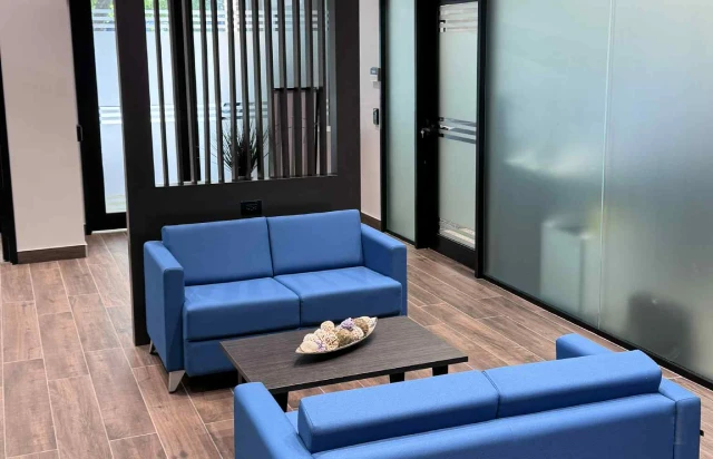 Meeting area with blue couches and coffee table
