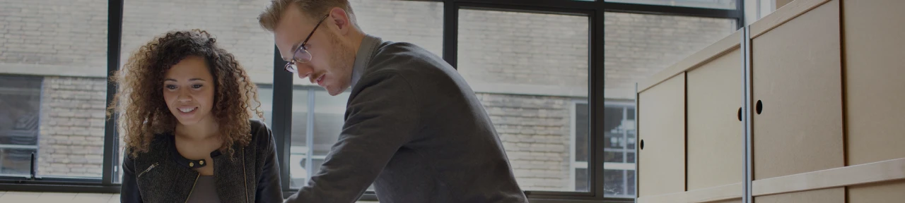 Man in Workshop Using Laptop for Business