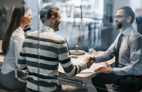 Couple Shaking Hands with Financial Advisor