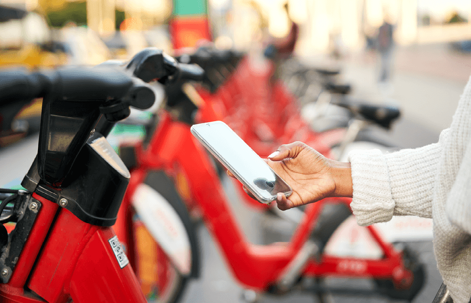 Person Using Mobile Phone to Pay for Scooter Online