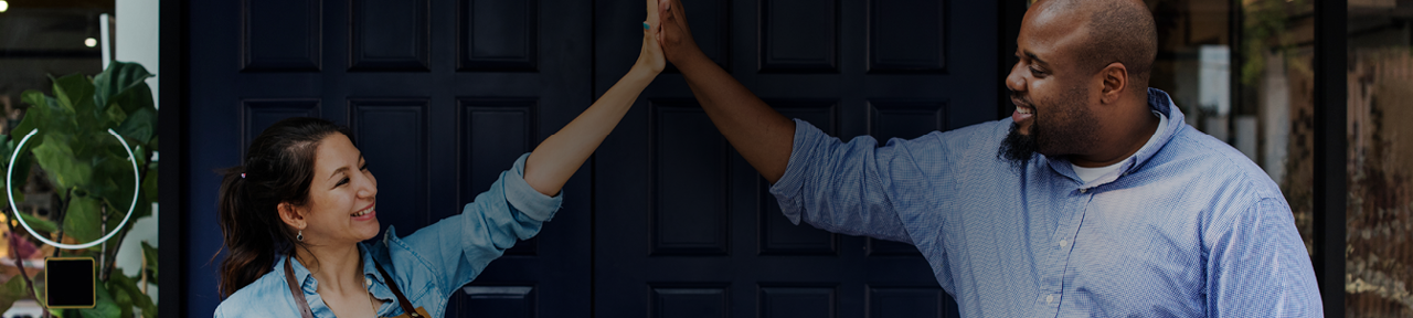 Business partners high fiving after opening store with the help of FirstOntario Business Banking