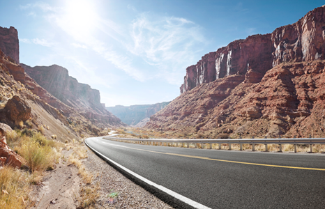 Sun Shining on Winding Road Through a Canyon