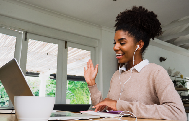 Woman Using Laptop to Meet Virtually