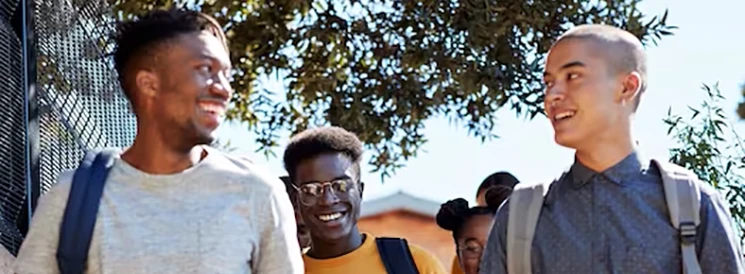 Three students walking and talking on their way home from school