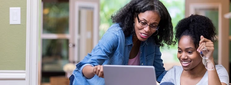 Mother helping daughter make a withdrawal from RESP for tuition