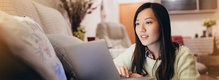 Woman researching fixed income investment options on laptop