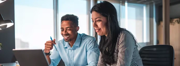 Smiling couple working on laptop to file their tax returns