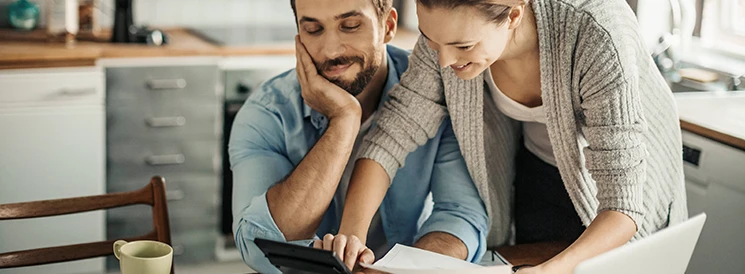 Couple doing their taxes at the kitchen table