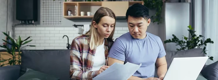 Young couple reviewing Will documents in the kitchen