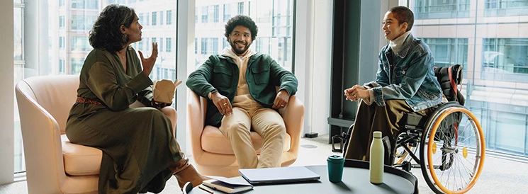 Three people sitting together in meeting room